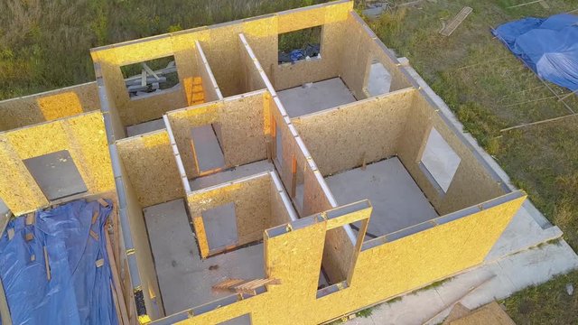 Construction of new and modern modular house. Walls made from composite wooden sip panels with styrofoam insulation inside. Building new frame of energy efficient home concept.