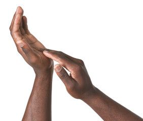 Hands of African-American man on white background