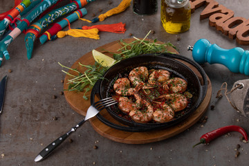 Shrimps on pan with fresh herbs and tomato sauce