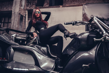 Fototapeta na wymiar fashionable young woman posing sitting on new trike