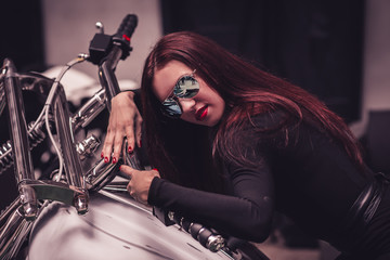 Fototapeta na wymiar close up. fashionable young woman sitting on a steep motorbike