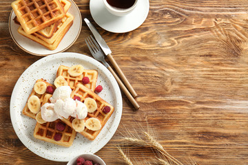 Composition with tasty waffles and cup of coffee on wooden background