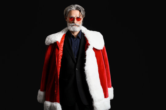 Portrait of stylish Santa Claus on dark background