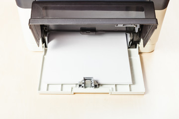 stack of white paper sheets in printer tray