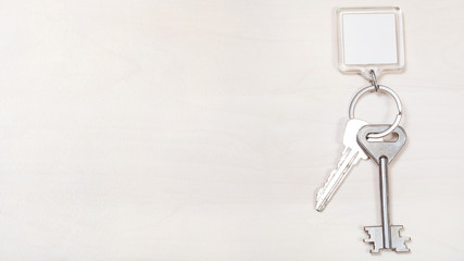 keys on keyring with blank white keychain on board