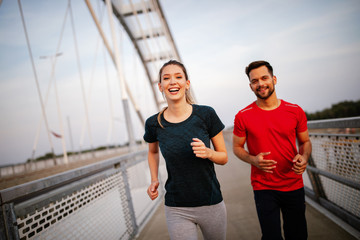 Obraz premium Healthy sporty young people jogging and running outdoors