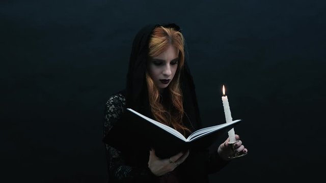 Gothic witch with book and candle