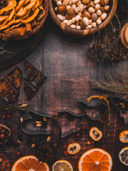 Mix of christmas spices, nuts, fresh and dried fruits, baking dish, christmas branch, selective focus