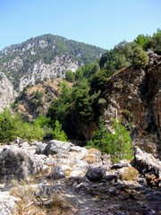 Fototapeta na wymiar Hiking through the famous Samaria Gorge in the White Mountains on the island of Crete, Greece. A major tourist attraction of the island 