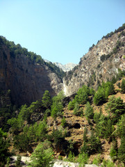 Hiking through the famous Samaria Gorge in the White Mountains on the island of Crete, Greece. A...