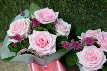 bouquet of pink roses with green leaves