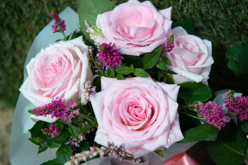 bouquet of pink roses with green leaves