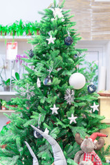 New Year's Toy ball and stars, snowflakes on a background of a green Christmas tree. Concept soft toys