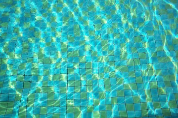 Fototapeta na wymiar Surface of water and flow with waves in swimming pool background. Relax concept.
