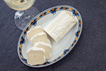 goat cheese on dish on ceramic background