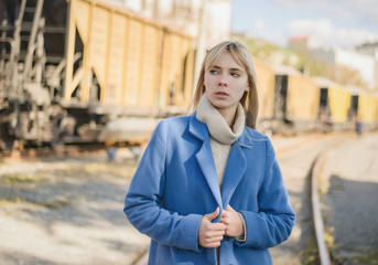Portrait of young woman wearing blue coat.
