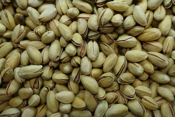 Heap of tasty pistachios texture background