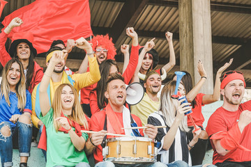 Friends football supporter fans watching soccer match event at stadium - Young people group having...