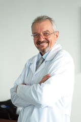 Doctor of medicine, scientist professor standing arms crossed and smiling