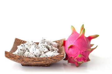 Whole and sliced piece dragon fruit or Pitaya in wooden plate isolated on white background.