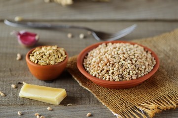 Wheat grain in dishes on the table.grains and wheat ears on a wooden table, top view