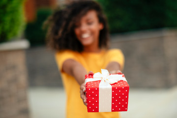 Portrait of young african woman with gift