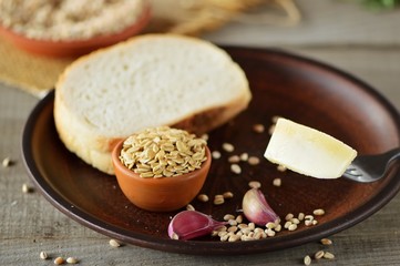 Wheat grain in dishes on the table.grains and wheat ears on a wooden table, top view