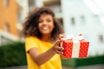 Portrait of young african woman with gift