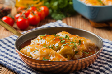 Traditional stuffed cabbage with minced meat and rice, served in a tomato sauce.
