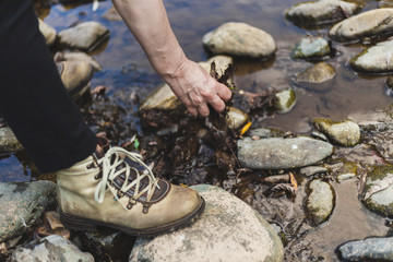 Hiking woman playing by the river