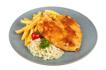 Fried heart-shaped chicken schnitzel. Served with fries and salad on a gray plate. Packshot.