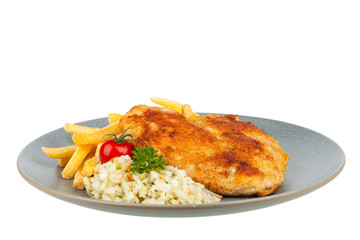 Fried heart-shaped chicken schnitzel. Served with fries and salad on a gray plate. Packshot.