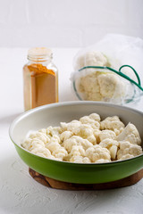 Turmeric and coconut milk baked cauliflower, vegetable recipe. Vegetarian or vegan diet, healthy food concept.