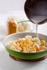 Turmeric and coconut milk baked cauliflower, vegetable recipe. Vegetarian or vegan diet, healthy food concept.