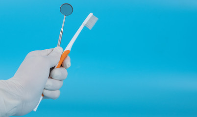 The dentist holds a mounted mirror to show the patient's dental examination.