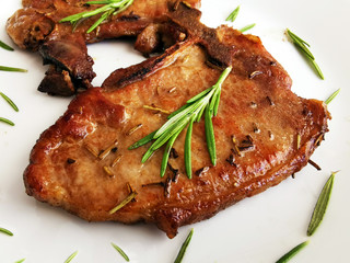 Fried pork chops on a white plate. Concept for Keto diet and healthy food.