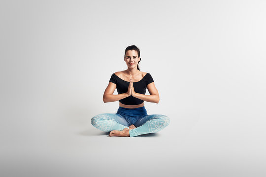 Yoga sitting pose, stretching, woman on white backgroung, studio photos