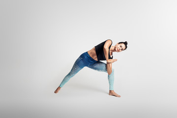 Yoga warrior pose, stretching, hands above head, woman on white backgroung, studio photos