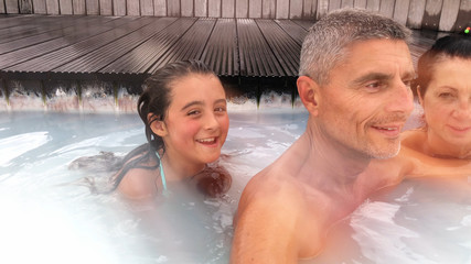 Family enjoying thermal bath pool