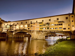 Fototapeta premium Old Bridge and Florence Lungarni at night. Panoramic cityscape in Autumn, Tuscany - Italy