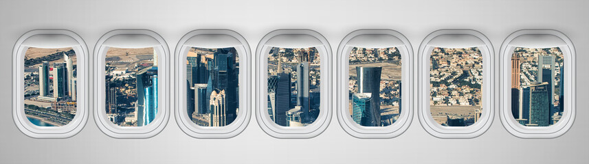 Airplane interior with window view of Doha City. Concept of travel and air transportation
