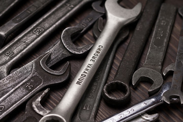 open end wrench set over the dark wood table. Hand tool. Instrument. Close-up. labor Day concept
