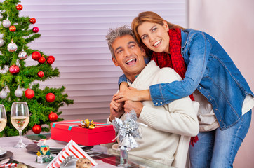 Obraz na płótnie Canvas Happy couple at home for Christmas. Happy family in holiday season