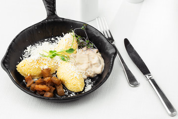 Typical Ukrainian dish polenta - Banosh with cheese, lard and white mushrooms. Maize porridge with...