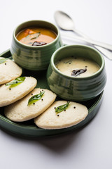 Idli Sambhar or Idly Sambar is a popular south Indian food, served with coconut chutney. selective focus