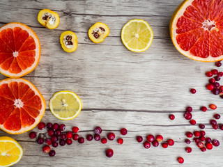 grapefruits, lemon, cydonia slices, red cranberries, top view. Natural vitamins and antioxidants food concept.