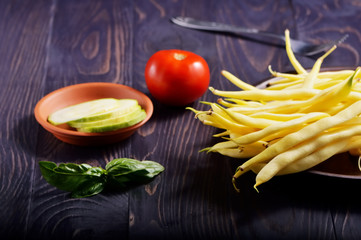 Obraz na płótnie Canvas Fresh vegetables on the table. Cutting a delicious salad for vegetarians.