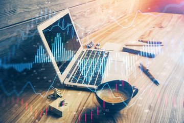 Multi exposure of graph and financial info and work space with computer background. Concept of...