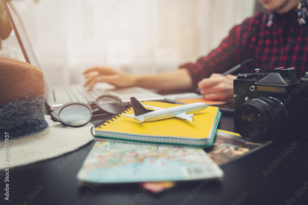 Wall mural wanderlust - woman planning next journey searching information online