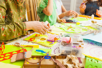 Children's art project, craft for children. Kids doing greeting card at creative workshop with...